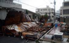 Structures collapsed during strong winds in Naha on Japan’s southern island of Okinawa on 8 July 2014. Typhoon Neoguri lashed Okinawa islands forcing over half a million people to seek shelter. Picture: AFP.