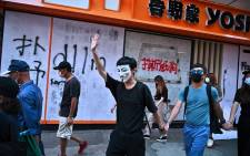 Graffiti is seen at the entrance of a fast-food restaurant as people take part in a flash mob rally in the Mongkok district in Hong Kong on 5 October 2019, a day after the city's leader outlawed face coverings at protests invoking colonial-era emergency powers not used for half a century. Picture: AFP