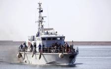 FILE: Illegal migrants of different African nationalities arrive at a naval base in the capital Tripoli on 6 May 2018, after they were rescued from inflatable boat off the coast of Al-Zawiyah. Picture: AFP
