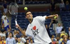 Novak Djokovic of Serbia hits balls to the fans after defeating Andreas Haider-Maurer of Austria during their US Open 2015 second round men’s singles match at the USTA Billie Jean King National Center 2 September, 2015 in New York. Picture: AFP.