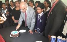 Ahmed Kathrada slices his birthday cake at SBSM School in Lenasia. Kathrada turns 86 today. Picture: Faizel Patel/EWN.