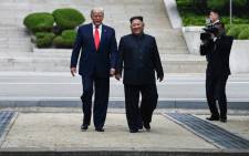 FILE: North Korea's leader Kim Jong Un walks with US President Donald Trump north of the Military Demarcation Line that divides North and South Korea, in the Joint Security Area (JSA) of Panmunjom in the Demilitarized zone (DMZ) on 30 June, 2019. Picture: AFP.