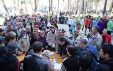 People queue to get their Russian passports in the Crimean capital of Simferopol on 24 March. Picture:AFP.