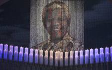 Candles are lit under a portrait of Neslon Mandela before the funeral ceremony of South African former president Nelson Mandela in Qunu on December 15, 2013. Picture: AFP