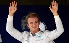 Mercedes German driver Nico Rosberg waves after clocking the pole position for Brazils GP tomorrow at the Interlagos racetrack in Sao Paulo, Brazil. Picture: AFP.