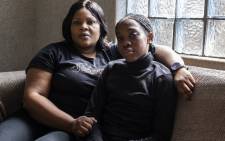 Tumelo Ledwaba (R), who is suffering from respiratory problems, and her mother, Nono Ledwaba, pose for a portrait in their house in eMpumelelweni Extension 6, near eMalahleni , part of the Highveld region turned over to mines and power plants, on 13 June 2019. Picture: AFP