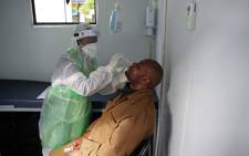 FILE: A City of Tshwane Health official takes a nasal swab to test for the COVID-19 coronavirus on a taxi operator at the Bloed Street Mall in Pretoria Central Business District, on 11 June 2020. Picture: AFP.