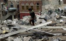 FILE: A Yemeni child inspects the rubble of a house in Yemen's rebel-held capital Sanaa after it was reportedly hit by a Saudi-led coalition air strike. Picture: AFP.
