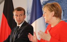 FILE: French President Emmanuel Macron (L) and German Chancellor Angela Merkel give a joint press conference on 19 June 2018, at the Meseberg Palace, northeastern Germany. Picture: AFP