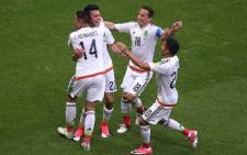 Mexico's forward Hirving Lozano (2nd L) celebrates a second goal during the 2017 Confederations Cup group A football match between Mexico and Russia at the Kazan Arena Stadium in Kazan on June 24, 2017. Picture: AFP.