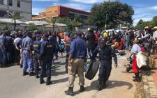 Police confiscate tyres from Alexandra protesters on the Grayston Bridge on 8 April 2019. Picture: Ayanda Nyathi/EWN