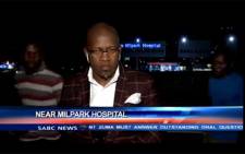 A screengrab shows SABC contributing editor, Vuyo Mvoko, being mugged outside Milpark Hospital in Johannesburg during live recording.