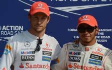 McLaren Mercedes' British driver Jenson Button (L) and McLaren Mercedes' British driver Lewis Hamilton pose in the parc ferme at the Autodromo Nazionale circuit IN Monza, Italy, on September 8, 2012. Picture: AFP.