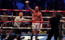 Britain's Tyson Fury (R) celebrates after knocking out Britain's Dillian Whyte in the sixth round to win their WBC heavyweight title fight at Wembley Stadium in west London, on 23 April 2022. Picture: Adrian DENNIS/AFP