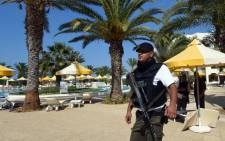 A Tunisian security member stands next to a swimming pool at the resort town of Sousse, a popular tourist destination 140 kilometres south of the Tunisian capital, on 26 June, 2015, following a shooting attack. Picture: AFP.