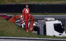 Ferrari driver Sebastian Vettel leaves the racetrack while a crane lifts his car during the F1 Brazil Grand Prix, at the Interlagos racetrack in Sao Paulo, Brazil on 17 November 2019. Picture: AFP