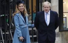 FILE: Britain's Prime Minister Boris Johnson with his partner Carrie Symonds leave after attending the annual Commonwealth Service at Westminster Abbey in London on 9 March 2020. Picture: Tolga AKMEN/AFP