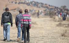 FILE: Platinum mineworkers gather on a hill during a strike meeting. Picture: EWN.