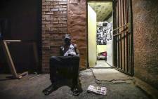 A Malawian refugee sits and listens to music after dinner at a sanctuary in Mayfair. Picture: Thomas Holder/EWN