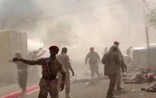 FILE: This AFPTV screengrab from a video made on 1 August 2019, shows Yemeni security forces rushing at the scene of a missile attack on a military camp west of Yemen's government-held second city Aden. Picture: AFP