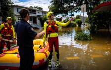 A Queensland Fire and Rescue Swift Water Rescue crew move through the flooded streets in the city of Paddington in suburban Brisbane on 28 February 2022. Picture: Patrick HAMILTON/AFP