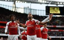 Arsenal's Gabonese striker Pierre-Emerick Aubameyang (C) celebrates after scoring the opening goal from the penalty spot during the English Premier League football match between Arsenal and Tottenham Hotspur at the Emirates Stadium in London on 2 December 2018. Picture: AFP