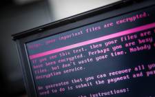 In this file photo taken on 27 June 2017 a laptop displays a message after being infected by a ransomware as part of a worldwide cyberattack in Geldrop. Picture: AFP