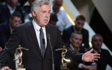  Paris Saint-Germain's Italian coach Carlo Ancelotti receives the Coach of the Season trophy on 19 May 2013. Picture: AFP.