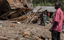 Family members and residents of the two villages affected by the floods look up at the damage caused by the disaster in Nyamukubi, eastern Democratic Republic of Congo, 8 May 2023. Picture: AFP