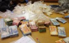 Drugs and money seized from two suspects during separate raids in Cape Town. Picture: SAPS.