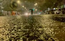 A person makes their way in rainfall from the remnants of Hurricane Ida on 1 September 2021, in the Bronx borough of New York City. Picture: David Dee Delgado/Getty Images/AFP