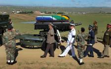 Nelson Mandela's casket is carried by police and military members during his funeral service in Qunu, 15 December 2013. Picture: GCIS.