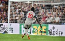 Liverpool's Senegalese striker Sadio Mane puts the ball into the open net after beating Crystal Palace's Welsh goalkeeper Wayne Hennessey to score their second goal during the English Premier League football match between Crystal Palace and Liverpool at Selhurst Park in south London on 20 August, 2018. Picture: AFP.