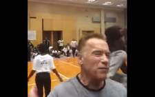 A screenshot of a fan kicking Arnold Schwarzenegger in the back at the Arnold Classic Africa Festival in Sandton. Picture: World's Strongest Fan/Youtube