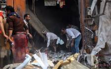 Yemenis inspect the damage of a building hit by a rocket during clashes between Shiite Huthi rebels and fighters from the Popular Resistance Committees, loyal to Yemen's fugitive President Abedrabbo Mansour Hadi, in the third city of Taez, on October 21, 2015. At least 22 civilians were killed and several others wounded as suspected rebel rockets crashed into the central Yemeni city of Taiz, according to medics and military officials. Picture: AFP.