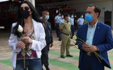 US pop singer Cher (L) holds a flower as she waits with Cambodia's Deputy Minister of Environment Neth Pheaktra (R) to greet the Asian elephant Kaavan upon his arrival in Cambodia from Pakistan at Siem Reap International Airport in Siem Reap on 30 November 2020. Picture: AFP.
