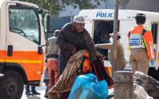 FILE: A homeless man from Doornfontein who is physically challenged struggles to lift some of his belongings which he will take to a shelter in Hillbrow. Picture: EWN