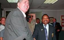 Dr Louis Luyt (L), President of South African Rugby Football Union (SARFU), shakes hands with Dr G. Sam, who led the delegation of National Sports Council (NSC), at NSC headquarters in Johannesburg 07 April. In a surprise move, SARFU boss Louis Luyt, who has been at the centre of the dispute, arrived at the talks after saying earlier he would not take part in the discussions. Picture: AFP.