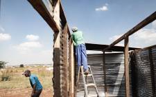 Residents of Kokotela informal settlement, in Lawley, rebuild their homes after 80 shacks were destroyed by the Red Ants. Picture: Sethembiso Zulu/EWN.