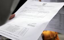 FILE: A pupil holds their matric report card. Picture: EWN