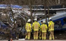 Firefighters stand at the site of a train crash near Bad Aibling, Germany, on 10 February 2016. At least 10 people were killed and 80 injured in the accident when two commuter trains collided on 09 February 2016. Picture: EPA/SVEN HOPPE.
