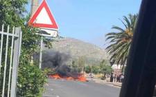 Burning tyres block a street in Ocean View, Cape Town, during a demonstration against crime by residents. Picture: Supplied. 