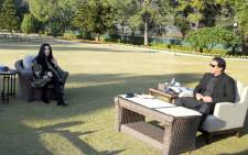 This handout photograph taken and released by Pakistan's Press Information Department (PID) on 27 November 2020 shows Pakistan's Prime Minister Imran Khan (R) meeting with American pop icon Cher in Islamabad. Picture: AFP.