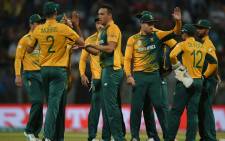 South Africa's Kyle Abbott (C) is congratulated by teammates after taking the wicket of England's Alex Hales during the World T20 cricket tournament match between England and South Africa at The Wankhede Stadium in Mumbai on March 18, 2016. Picture: AFP.