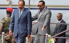 Eritrea president Isaias Afeworki (L) is welcomed upon arrival by Prime minister of Ethiopia Abiy Ahmed on 14 July, 2018 at Addis Ababa Bole International Airport for his official visit to Ethiopia. Picture: AFP