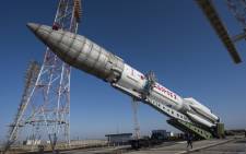 A handout picture taken and released by the European Space Agency (ESA) on 11 March, 2016 shows the Russian Proton rocket that will launch on 14 March the ExoMars 2016 spacecraft to Mars, during its transfer to the pad of the launch complex at the Baikonour spaceport, Kazakhstan. Picture: AFP.