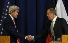 US Secretary of State John Kerry and Russian Foreign Minister Sergei Lavrov shake hands at the conclusion of their press conference following their meeting in Geneva where they discussed the crisis in Syria. Picture: Pool/AFP.