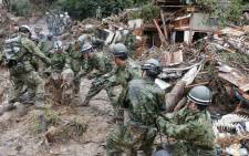 Defense personnel search for victims in mud two days after a landslide hit a residential area in Hiroshima, western Japan on late 22 August, 2014. Picture: AFP.