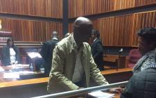 Murder accused former Jozi FM DJ, Donald Sebolai talks to a relative inside Palm Ridge Magistrate Court on 28 July 2015. Picture: Thando Kubheka/EWN.