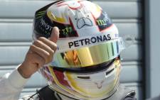 Pole position winner Mercedes AMG Petronas F1 Team's British driver Lewis Hamilton celebrates after the qualifying session at the Autodromo Nazionale circuit in Monza on 5 September 2015 ahead of the Italian Formula One Grand Prix. Picture: AFP